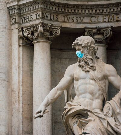 Neptune statue at the trevi fountain with a surgical maskの写真素材