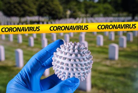 Coronavirus ball and Thombstones in National cementery on the backgroundの写真素材