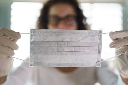 Pandemic Coronavirus. Close up of young woman with surgical maskの写真素材