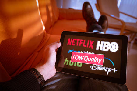 Barcelona, Spain. January 2019: Man holds a tablet with Netflix, hulu, amazon video, HBO and Disney plus logos on screenのeditorial素材