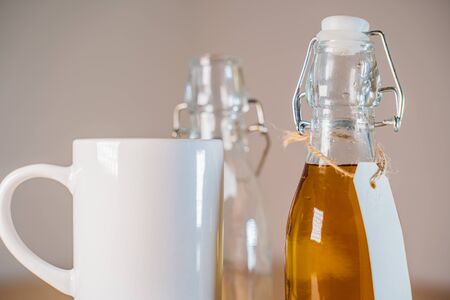 Close up view of glass bottle with a blank tag of apple juice or ciderの写真素材