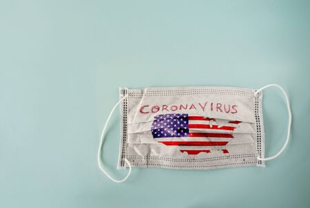 White medical mask with USA map isolated on cyan backgroundの写真素材