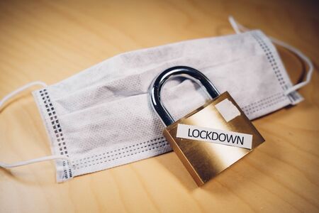 Closed padlock over a surgical face mask