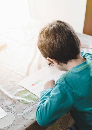 Kid doing homework from home during lockdownの写真素材