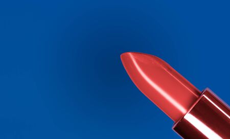 Beautiful bright red lipstick and classic blue complementary color on the backgroundの写真素材