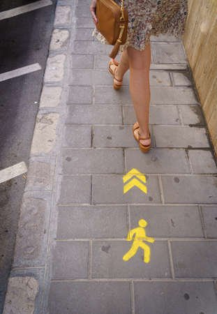 One-way pedestrian sign on the floor to maximize the social distance and preventively prevent contagion by covid-19の写真素材
