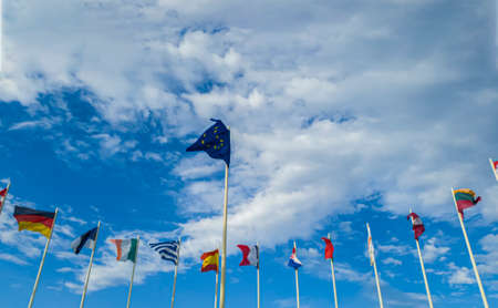 Flags Of European Countries on Flagpoles against a cloudy skyの写真素材