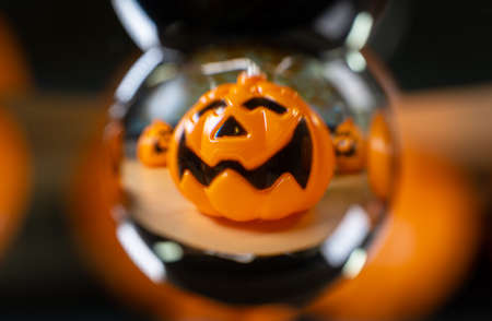 Halloween orange pumpkin seen through a crystal ballの写真素材