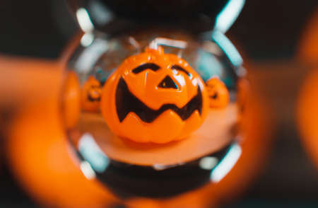 Halloween orange pumpkin seen through a crystal ballの写真素材