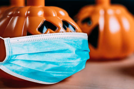 Orange pumpkin wearing a protective medical mask.の写真素材