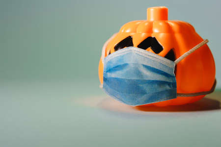 Orange pumpkin wearing a protective medical mask.の写真素材