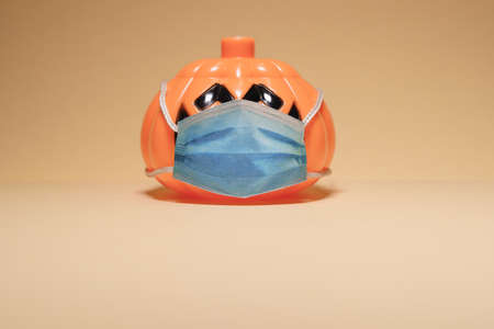 Orange pumpkin wearing a protective medical mask.の写真素材