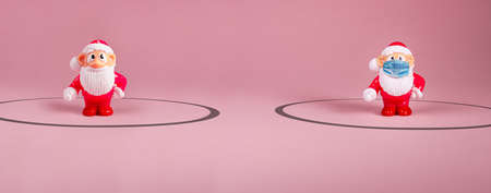 Santa Claus figures keeping social distance. Covid 19 concept