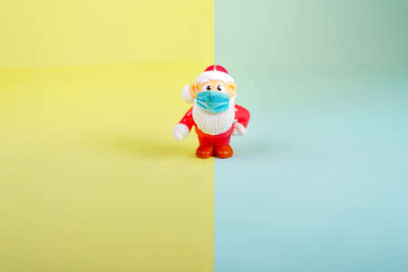 Santa Claus toy figure with face surgical mask.の写真素材