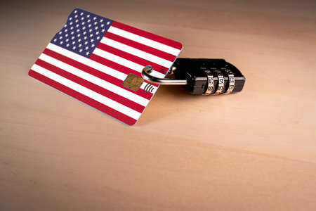 Padlock closed around a credit card with USA flagの写真素材