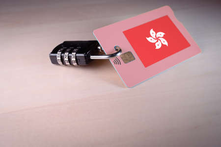 Padlock closed around a credit card with Hong Kong flagの写真素材