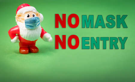 Santa Claus toy figure with face surgical mask.の写真素材
