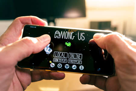 Barcelona, Spain. October 2020: Playing the popular Among us game app on the smartphoneのeditorial素材