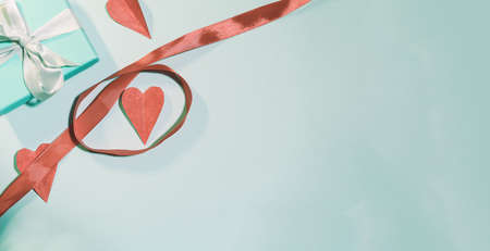 Valentines Day background. Gifts, candle, confetti, envelope on pastel blue background. Valentines day concept. Flat lay, top view, copy spaceの写真素材