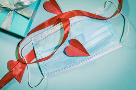 handmade heart made of paper on top of a face mask. Valentines day concept.の写真素材