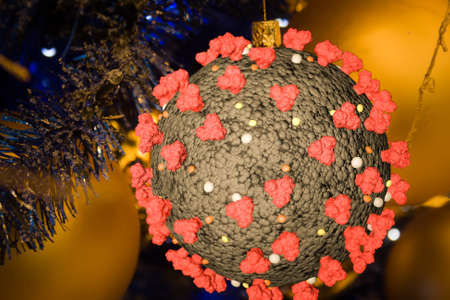Coronavirus as Christmas decorations on a Xmas treeの写真素材