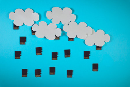 Cloud computing concept, paper clouds with micro SD cards as raindropsの写真素材