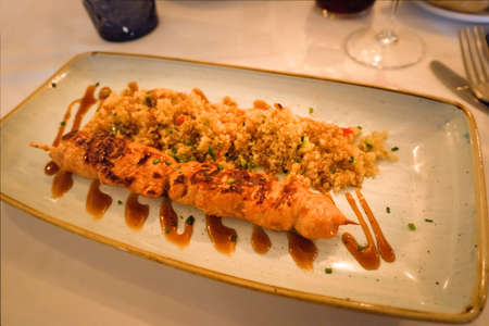 teriyaki chicken brochette served with quinoa saladの写真素材