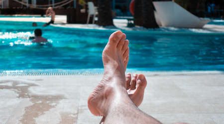 Caucasian man resting and relaxing in the pool once you can go back to travel and enjoy the vacation.の写真素材