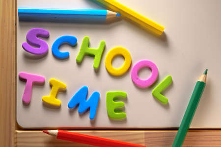 wooden table with school time text. Concepts of education from home or back to schoolの写真素材