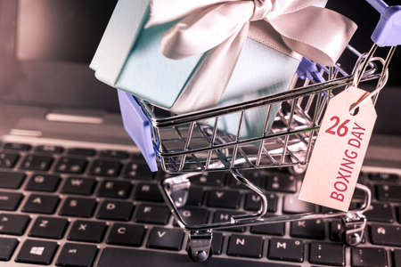 Small shopping cart with a gift inside and a Boxing day tagの写真素材