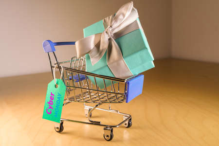 Small shopping cart with a gift inside and a Cyber monday frenzy tagの写真素材