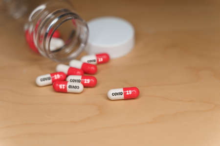 Antiviral pills for covid-19 scattered over a tableの写真素材