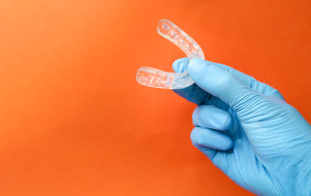 doctor holding a dental retainer or dental splintの写真素材