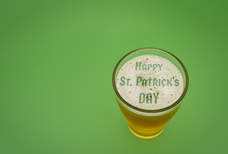 Glass of beer with the text Happy St Patricks dey in the foamの写真素材