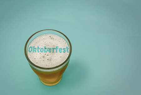 Glass of beer with the text Oktoberfest in the foamの写真素材
