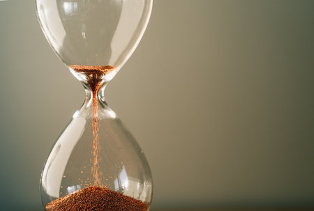Hourglass measuring the passing time in a countdown to a deadlineの写真素材