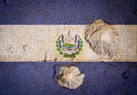 Stone wall with the flag of El Salvador and Bullet holesの写真素材