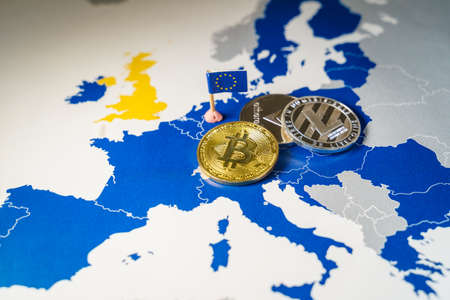 Financial concept with golden Bitcoin, Litecoin and Ethereum over and EU mapの写真素材