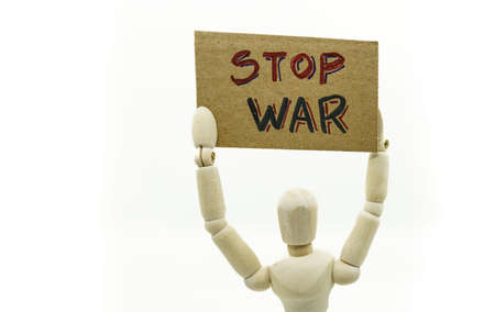 wooden dummy holding a sign with the text Stop war.の写真素材