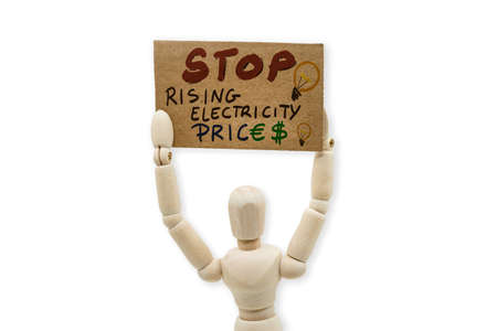 wooden dummy holding a sign with the text Stop wrising electricity prices.の写真素材