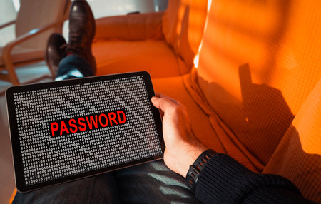 Man holding a tablet with the word Password on screen.の写真素材