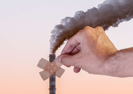 hand putting plaster ona smoke stackの写真素材