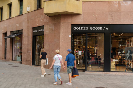 Barcelona, Spain. October 10, 2022: Tourists passing the window display outside a Golden Goose store in Passeig de Gracia street in Barcelona.のeditorial素材