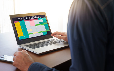 business person using agenda on computer. Time blocking conceptの写真素材