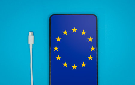 USB-C cable and a smartphone with the European Union Flag on screenの写真素材
