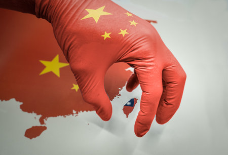 Hand grabbing the island of Taiwan on a mapの写真素材