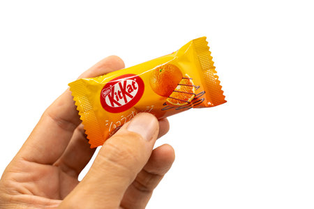 Barcelona, Spain. September 1st 2023: Hand hlolding a Nestle Japanese Kitkat Orange Chocolate flavoured .のeditorial素材
