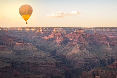 Hot air balloon Flying over the Grand Canyon during golden hourの写真素材