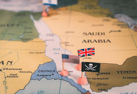 Flags of USA and UK surrounding the skull and crossbones pirate flag. The Red Sea Conflict Concept. vertical video.の写真素材