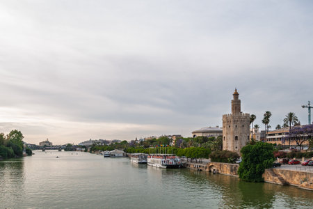 Torre del oro reflecting on guadalquivir river in seville, andalusia, spainの写真素材
